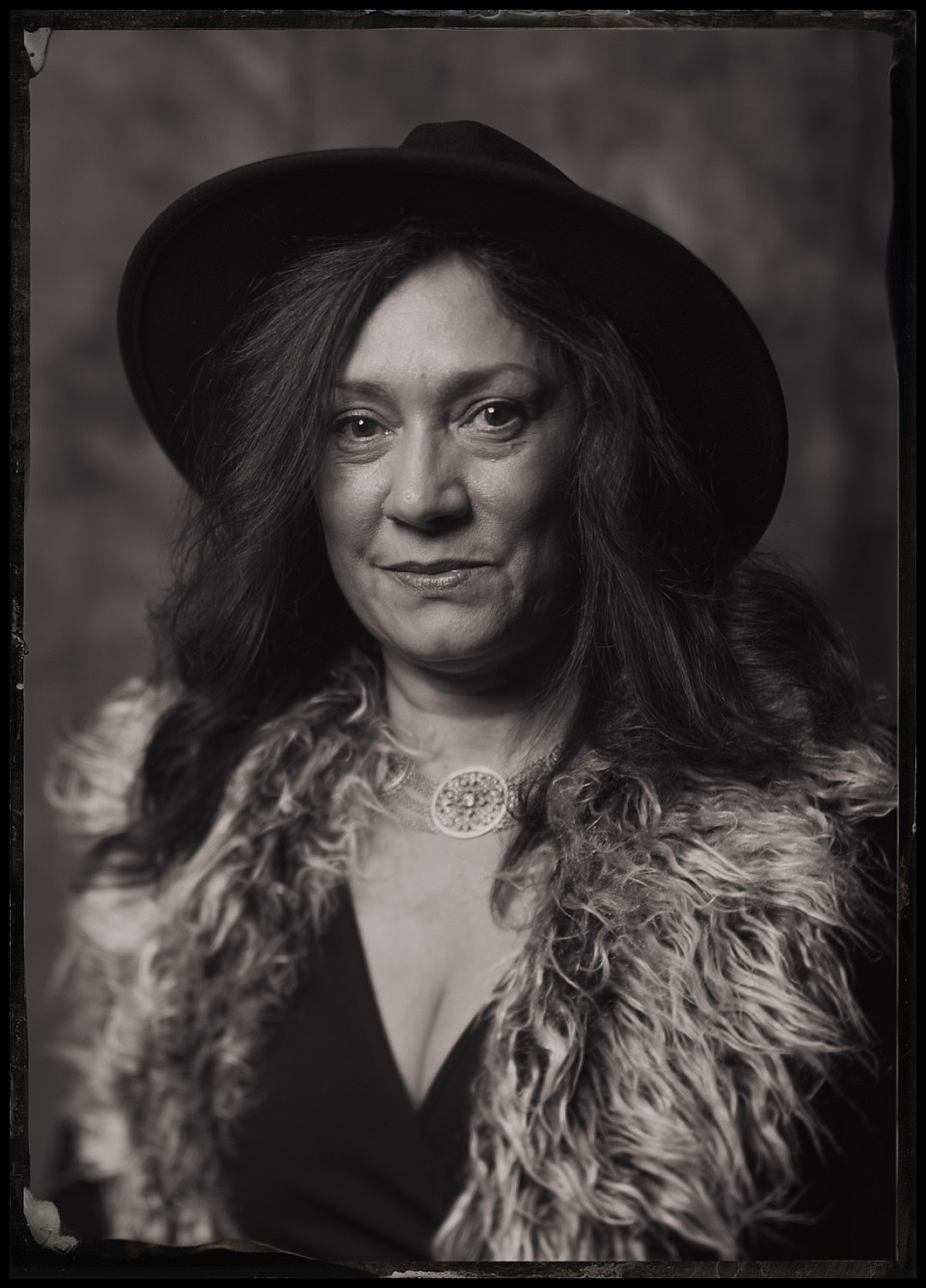 caribou club wedding welcome party tintypes in aspen portrait of woman in hat with faux fur vest