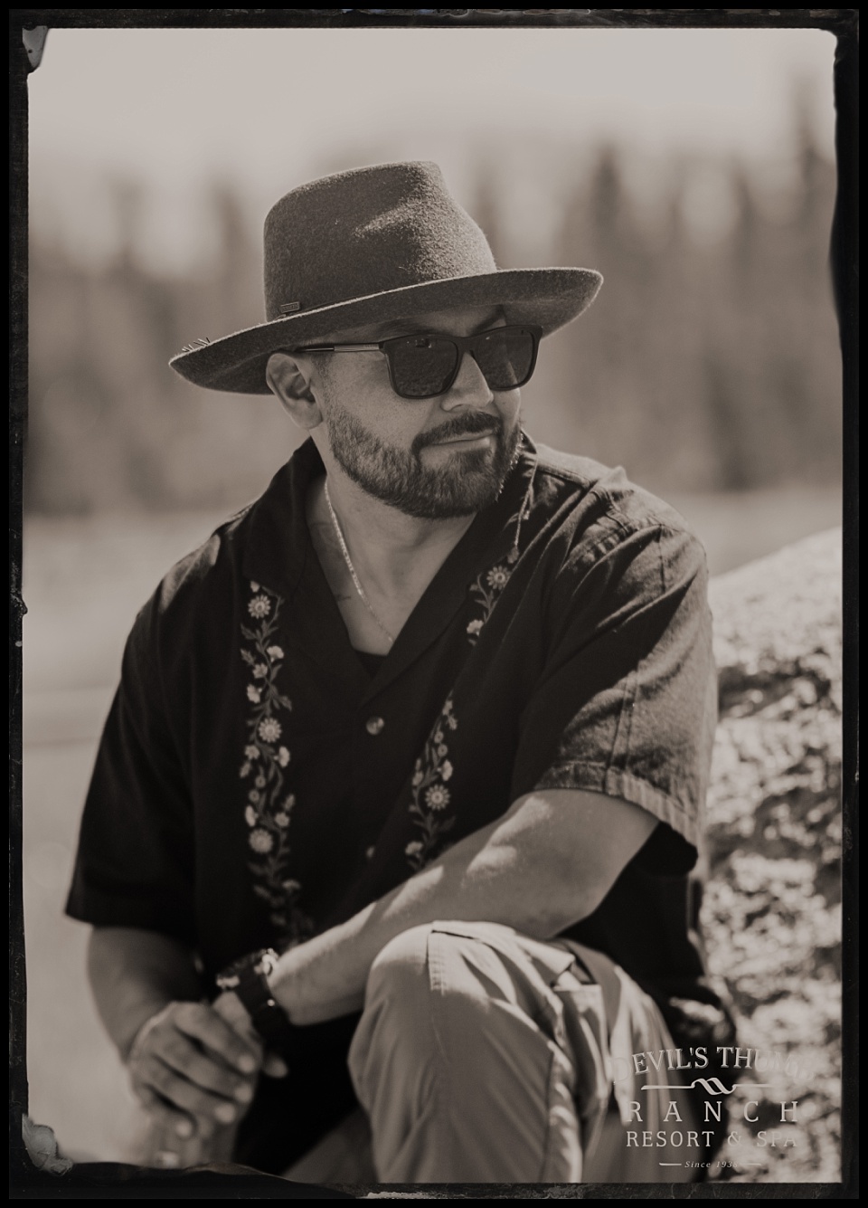 labor day tintypes devils thumb ranch man in black shirt, hat, and sunglasses looking cool